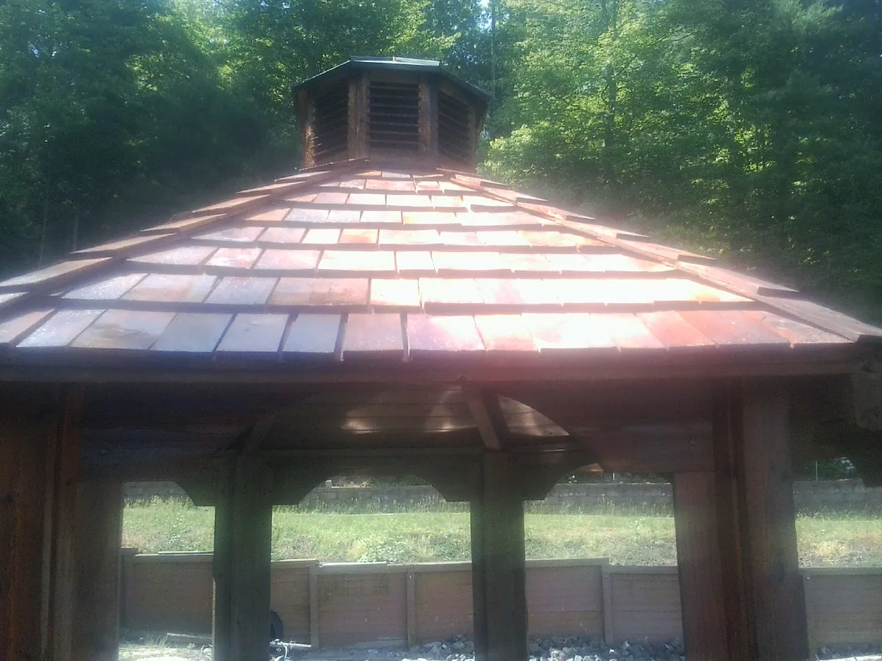 New cedar shake roof and cupola on a lakeside gazebo in Albion
